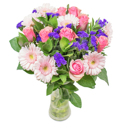 Crafted with the care and artistry that defines Tottenham's local florists, this radiant bouquet showcases an interplay of blush-hued gerberas and classic pink roses, each bloom chosen for its purity and form. The pinks, reminiscent of early morning skies over Bruce Grove, blend gracefully as if painted by watercolour - soft, inviting, and luminous. Deep purple statice punctuates the design, lending pops of cheerful colour and subtle texture reminiscent of handpicked wildflowers at Tottenham Green. Crisp, dewy leaves provide an invigorating foundation, cooling the eye and celebrating the lush greenery found along Lordship Recreation Ground. Bathed in gentle daylight and presented in a slender glass vase, the arrangement seems to glow, inviting viewers to reach out and explore its textures and fragrances. The bouquet is equally suited to serve as a gentle get-well gesture, a celebration of a new beginning, or a serene centrepiece for a Tottenham living room. Embodying the spirit and joy of the community, it exemplifies thoughtful craftsmanship and brings a lasting sense of optimism and comfort to all who receive it.