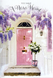 This scene shows a softly romantic entrance to a Tottenham home, captured at the very moment when flowers and architecture seem to speak the same gentle language. A pale, powdery pink door stands at the centre, freshly painted and subtly glossy, reflecting a wash of daylight that makes the whole frame feel luminous. The surrounding walls are whitewashed, their slightly textured surface catching light and shadow in a way that gives the setting depth and character, reminiscent of the charming terraces found around the edges of Lordship Recreation Ground. Above the door, a cascade of wisteria in delicate shades of lavender and lilac drapes down like a natural curtain. Clusters of tiny, bell-shaped blossoms gather into trailing garlands, some hanging low enough to almost brush the top of the door, evoking the soft, sweet scent that wisteria is known for in late spring. Beneath this floral canopy, a carefully curated arrangement of flowers sits poised on the doorstep in a grey tin bucket. The bucket's simple, slightly rustic design pairs beautifully with the refined blooms within it. Lush white and cream roses, each with tightly layered, velvety petals, fill the container to overflowing, while sprigs of fresh greenery weave between them, adding contrast and a sense of movement. Around the base of the bucket, a pale pink ribbon is tied in a relaxed yet precise bow, its satin sheen catching the light and echoing the tones of both roses and door. Soft sunlight filters through the wisteria, casting faint shadows on the steps and creating a tranquil, hopeful atmosphere-perfect for imagining this as a housewarming bouquet delivered to a new home in Tottenham, carrying wishes of comfort, joy, and a beautifully welcoming start.
